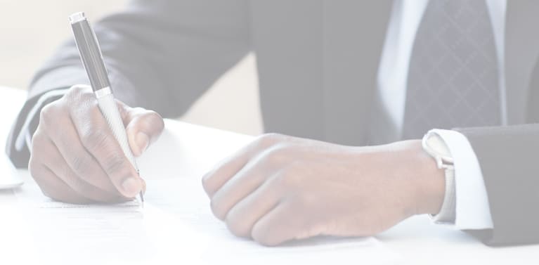 
A close-up of a person signing a document